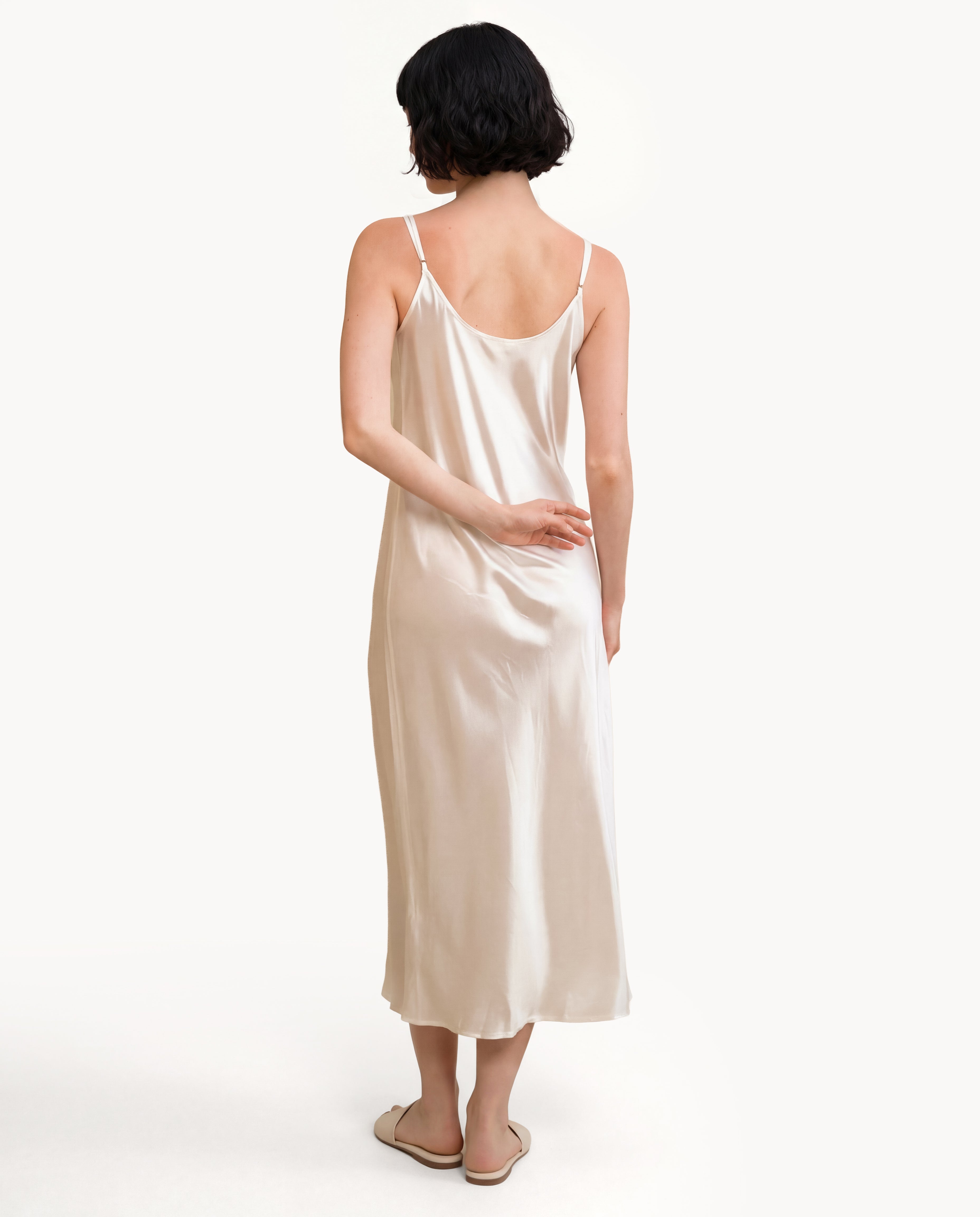 Back view of an Ivory NORA silk nightgown, an elegant nightgown made of mulberry silk fabric with a graceful floor-length drape.