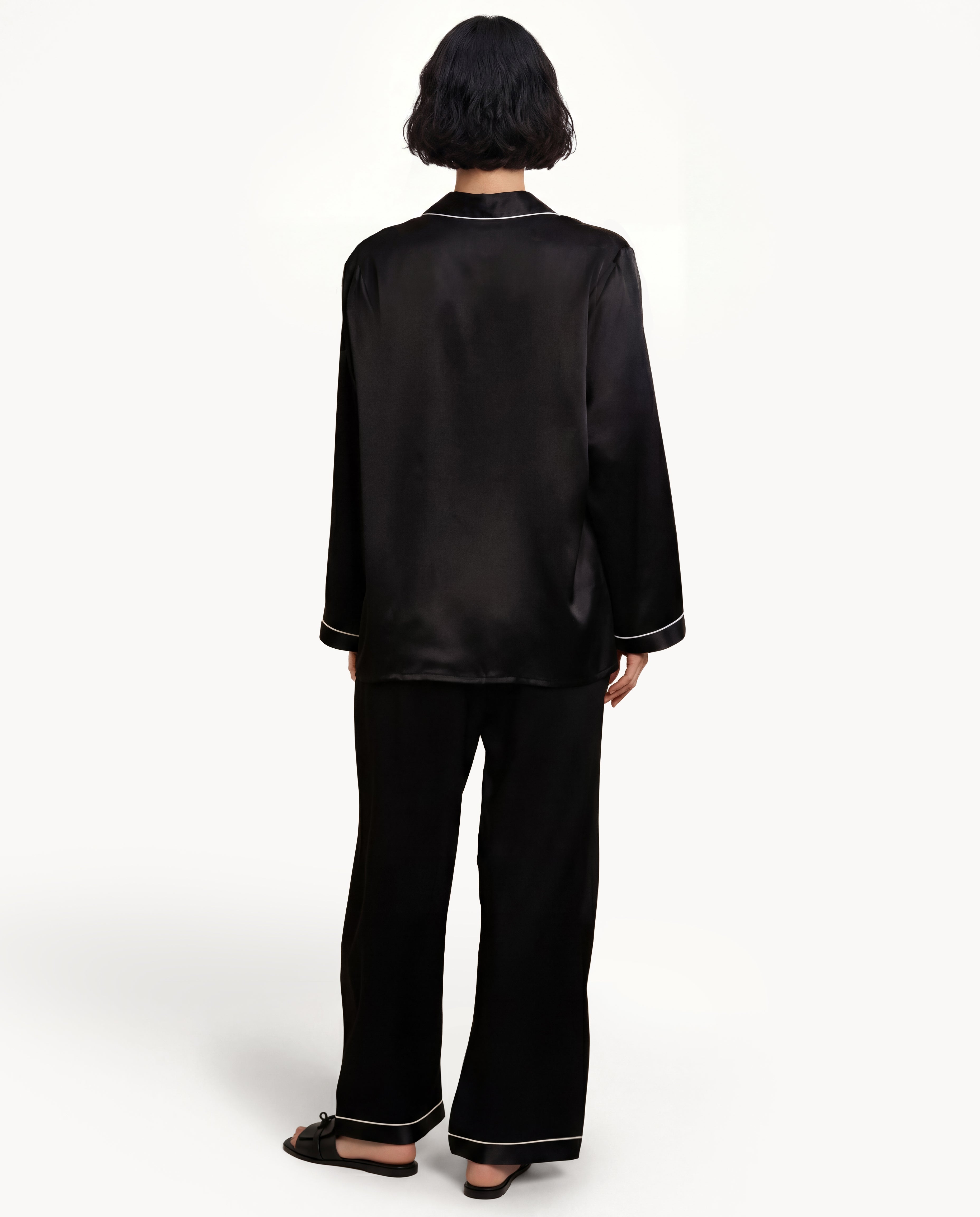 Back view of model in Black silk pajamas, real silk silk material pajama shirt and silk sleepwear gown for adult pajamas and black pjs.