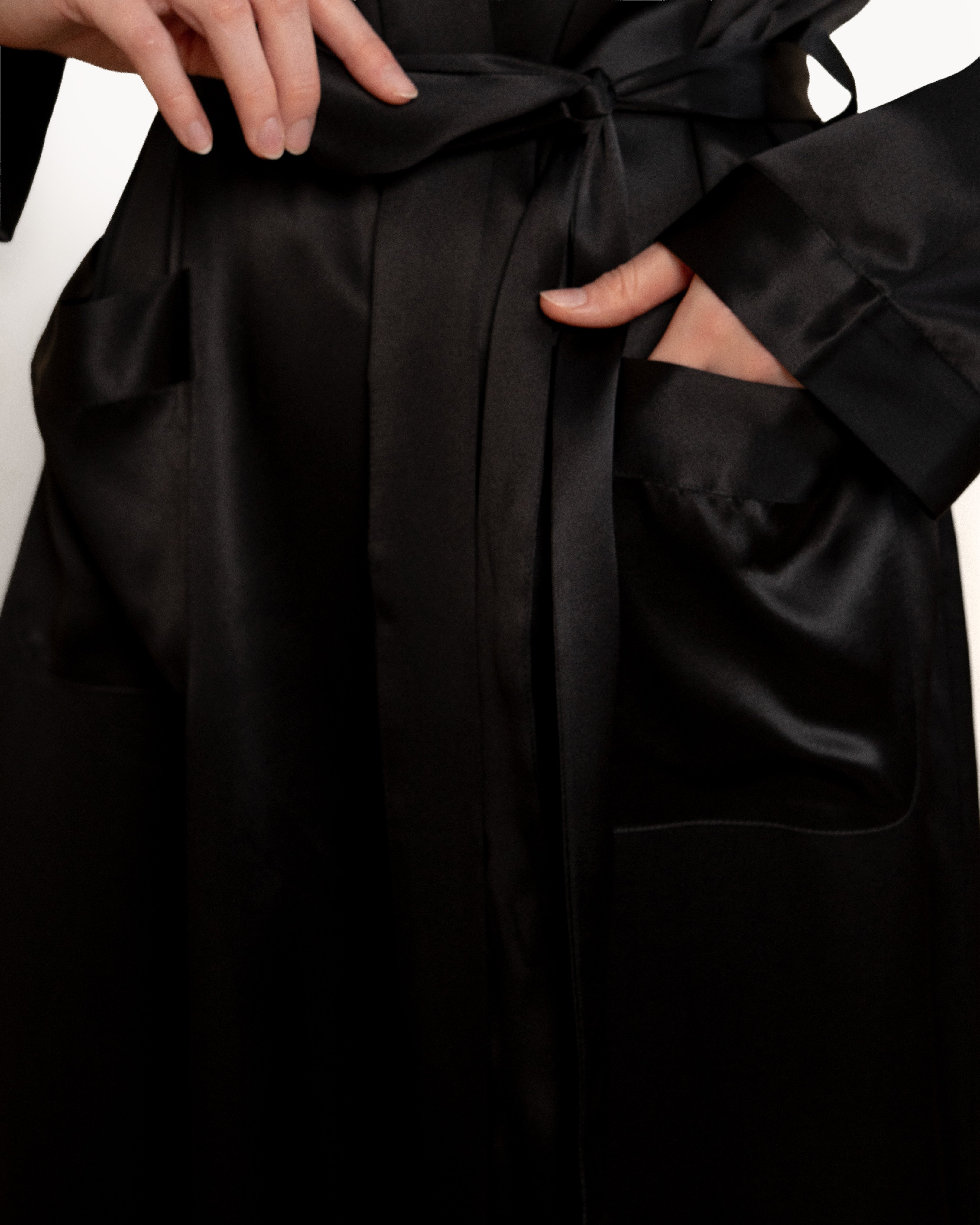 Detail of pocket on NORA black silk robe, functional silk bathrobe feature in luxury silk robes.
